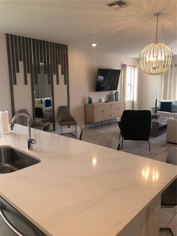 820 Driving Range Court Reunion, FL 34747 - Photo 11 of 45 a living room with furniture and a flat screen tv