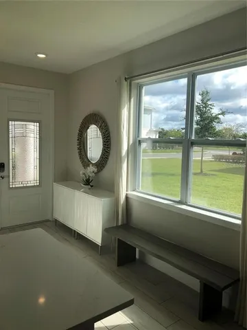 a living room with hardwood floor and a large window