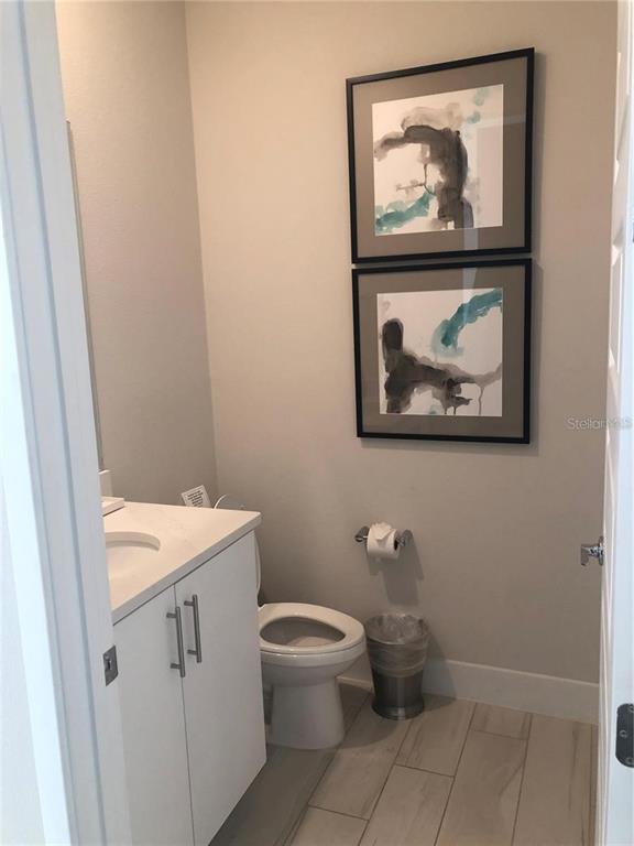 820 Driving Range Court Reunion, FL 34747 - Photo 18 of 45 a bathroom with a toilet a sink and a mirror