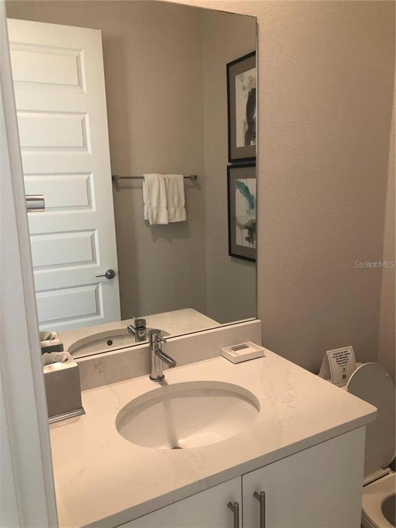 820 Driving Range Court Reunion, FL 34747 - Photo 19 of 45 a bathroom with a sink and a mirror