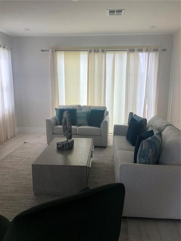 820 Driving Range Court Reunion, FL 34747 - Photo 2 of 45 a living room with furniture and a large window