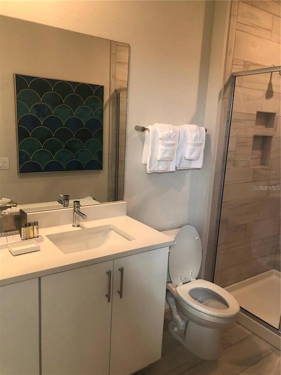 820 Driving Range Court Reunion, FL 34747 - Photo 22 of 45 a bathroom with a sink toilet and mirror