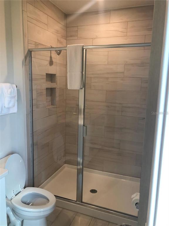 820 Driving Range Court Reunion, FL 34747 - Photo 23 of 45 a bathroom with a shower a toilet and a sink