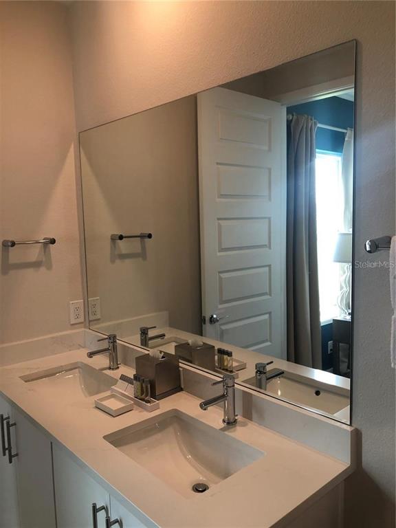 820 Driving Range Court Reunion, FL 34747 - Photo 24 of 45 a bathroom with a sink and a mirror