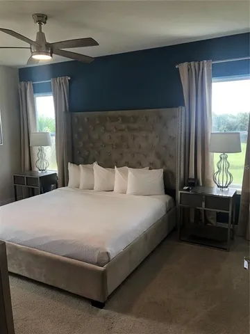 a bed sitting in a bedroom next to a window