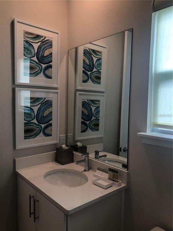 820 Driving Range Court Reunion, FL 34747 - Photo 30 of 45 a bathroom with a sink and a mirror