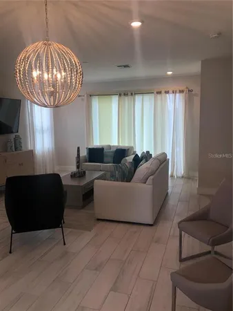 a living room with furniture and a large window