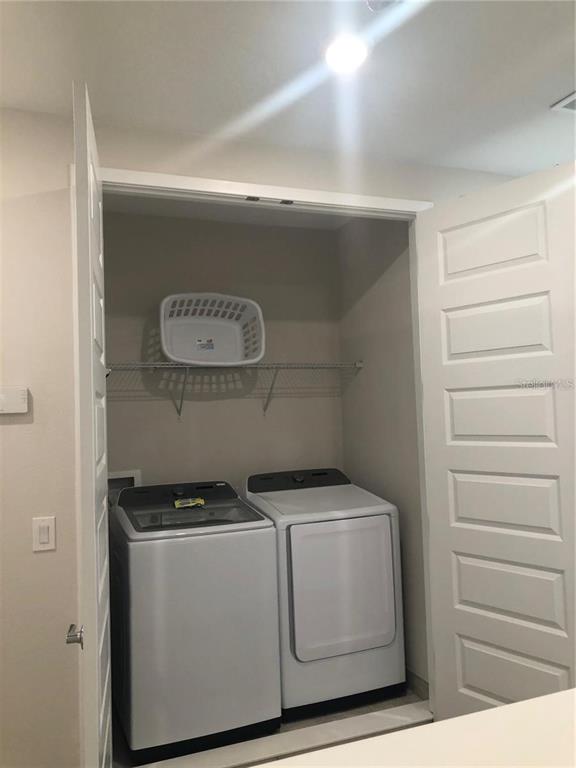 820 Driving Range Court Reunion, FL 34747 - Photo 32 of 45 a utility room with dryer and washer