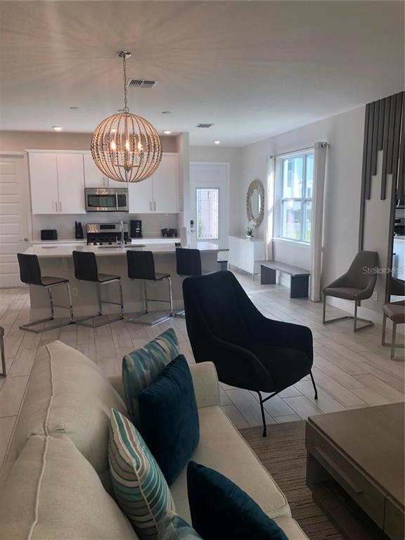 820 Driving Range Court Reunion, FL 34747 - Photo 5 of 45 a living room with furniture chandelier and a chandelier