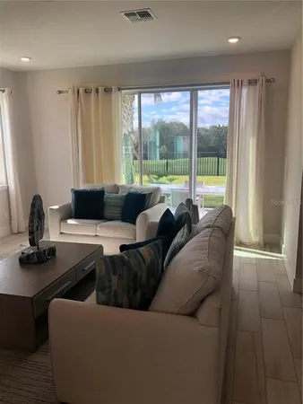 a living room with furniture and a large window