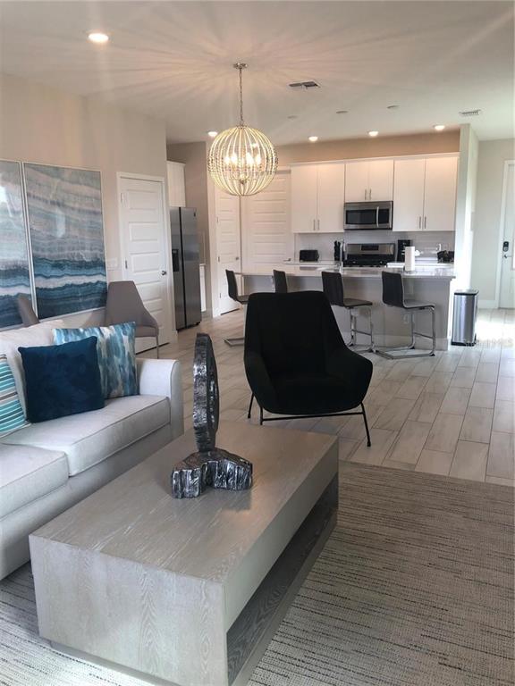 820 Driving Range Court Reunion, FL 34747 - Photo 9 of 45 a living room with furniture and kitchen view