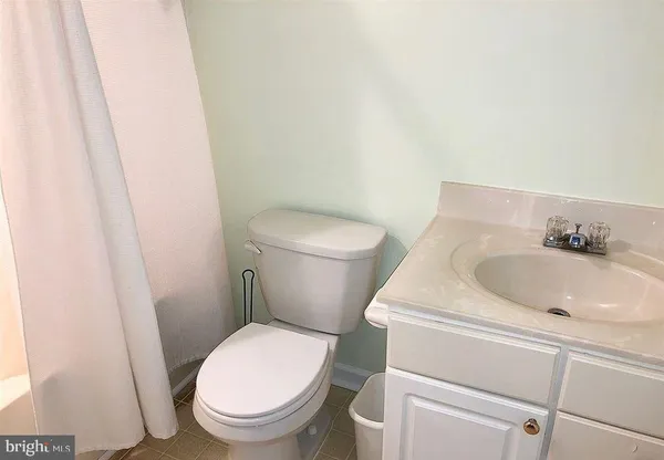 a white toilet sitting next to a sink