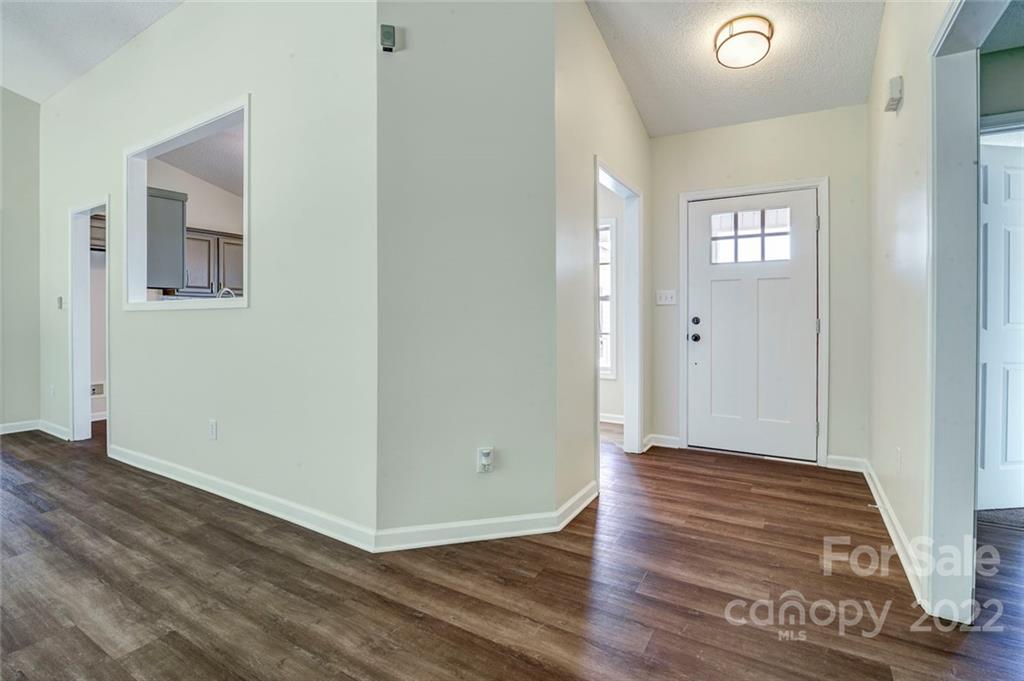 1022 Piney Church Road Concord, NC 28025 - Photo 3 of 16 a view of an empty room with wooden floor and a window