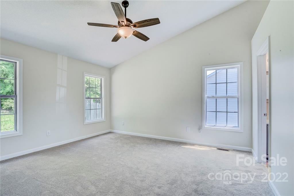 1022 Piney Church Road Concord, NC 28025 - Photo 9 of 16 an empty room with windows and fan