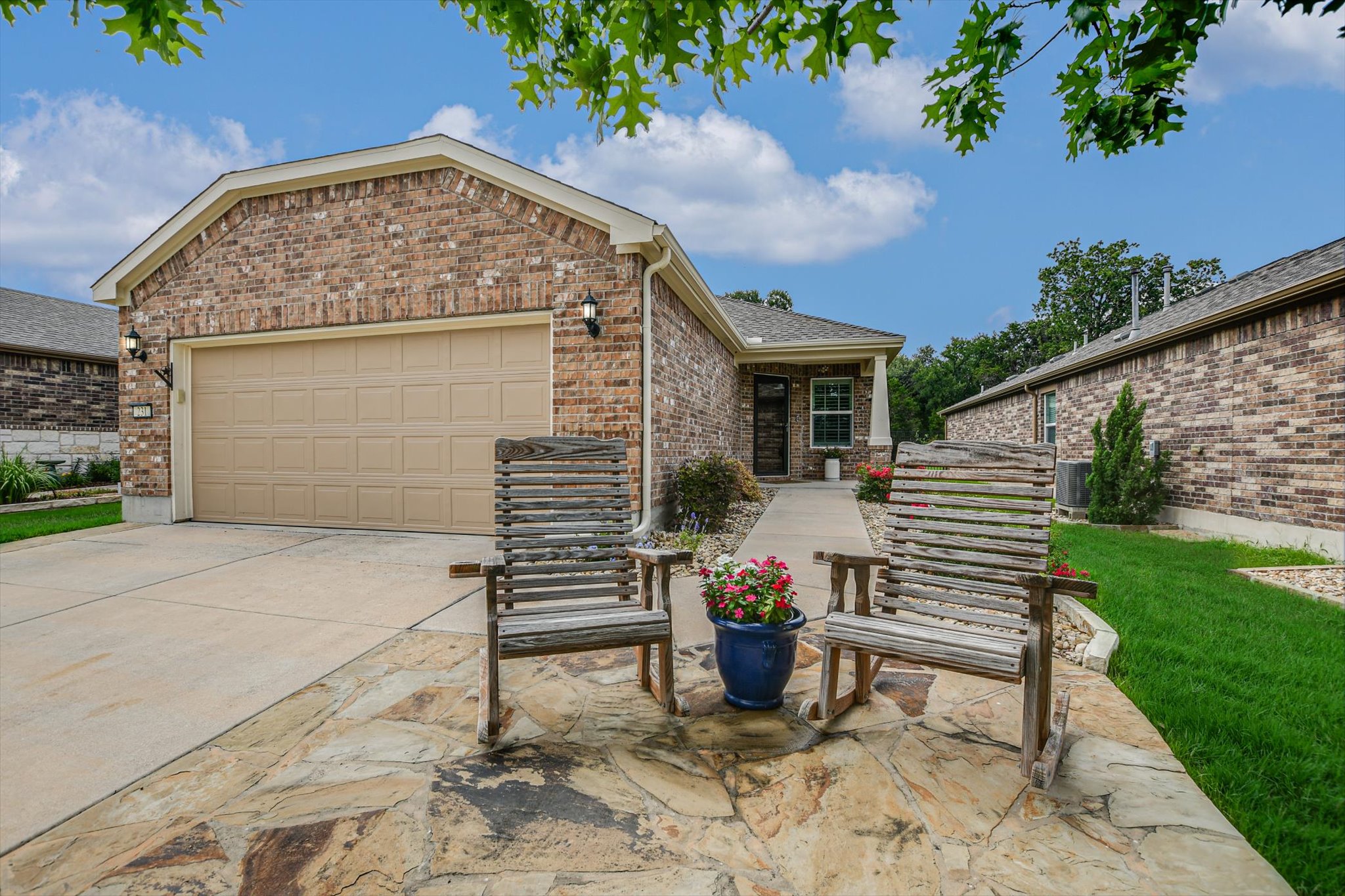 231 Hobby Street Georgetown, TX 78633 - Photo 2 of 29 A classic brick exterior offers enduring appeal, complemented by a spacious driveway and welcoming entry.