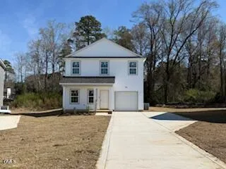 a front view of a house with yard