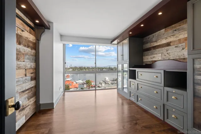 a bedroom with a bed and glass walk in closet