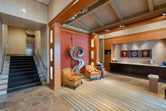 a view of a livingroom with furniture and staircase