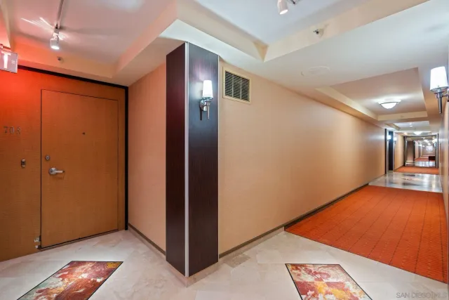 a open kitchen with stainless steel appliances granite countertop a refrigerator a stove and a wooden floors