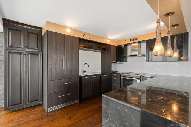 a kitchen with stainless steel appliances granite countertop a stove and a sink