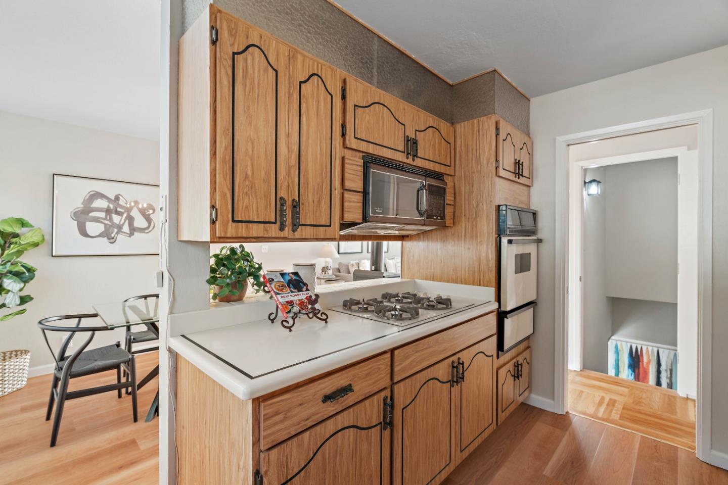 1212 Seville Drive Pacifica, CA 94044 - Photo 12 of 37 a kitchen with stainless steel appliances granite countertop a stove a sink dishwasher and a refrigerator with wooden floor