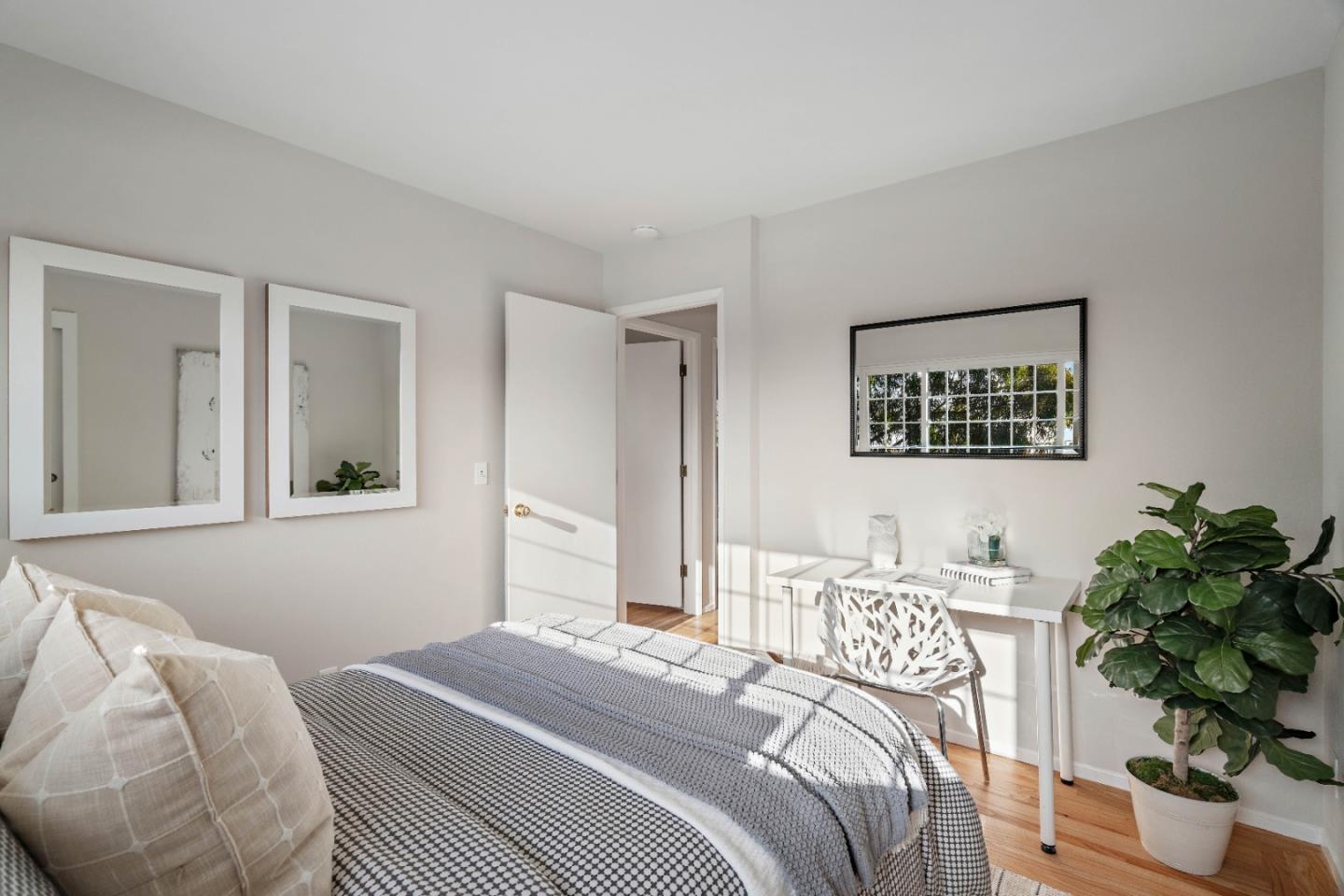 1212 Seville Drive Pacifica, CA 94044 - Photo 15 of 37 a bedroom with a bed potted plant and a window