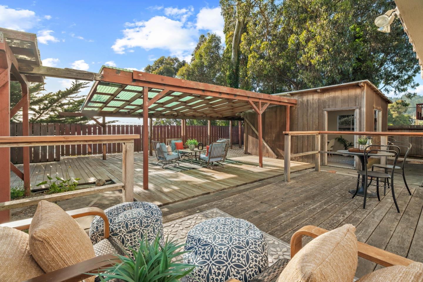 1212 Seville Drive Pacifica, CA 94044 - Photo 28 of 37 a view of a patio with table and chairs with wooden floor and fence