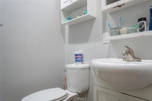 a bathroom with a sink toilet and a mirror