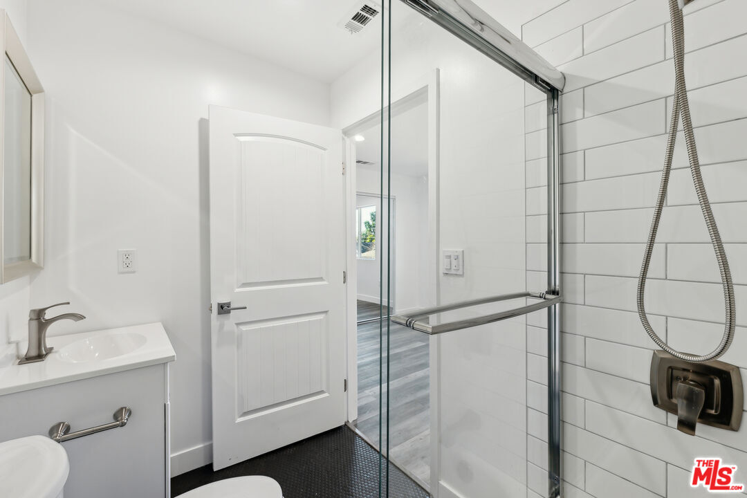 17610 Sherman Way, Unit 3 Van Nuys, CA 91406 - Photo 7 of 19 a bathroom with a shower and a sink