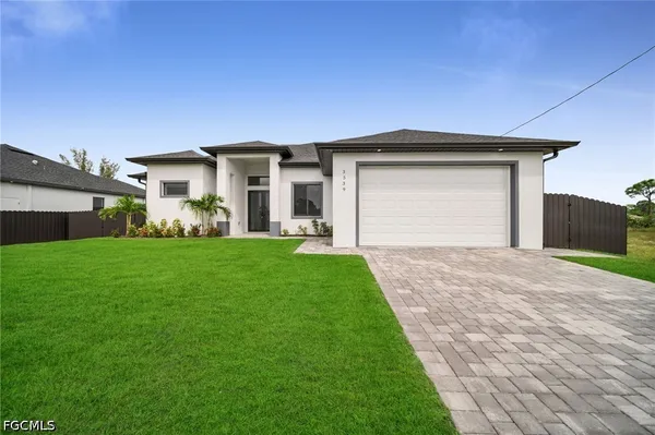 a front view of a house with a yard and garage