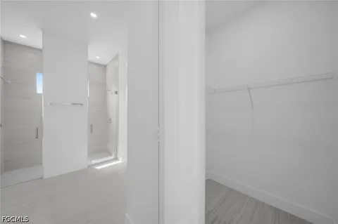 a bathroom with a granite countertop toilet a sink and shower