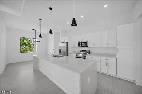 a kitchen with a sink stove and microwave