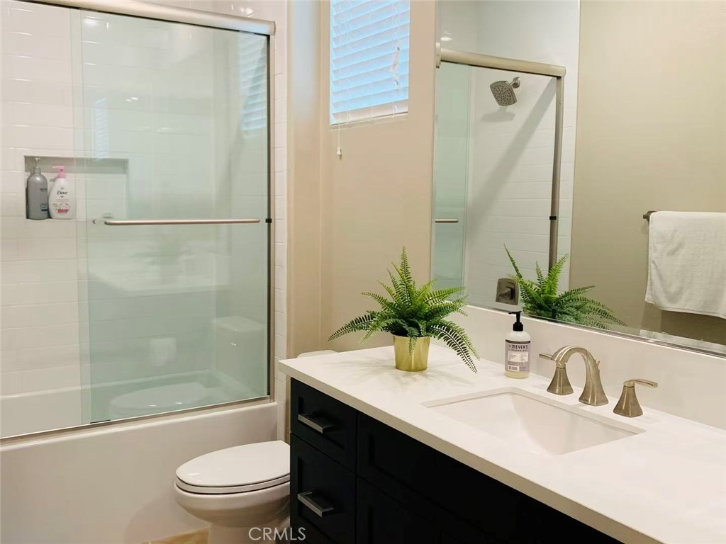 170 Scale Irvine, CA 92618 - Photo 8 of 9 a bathroom with a sink a toilet a mirror and shower