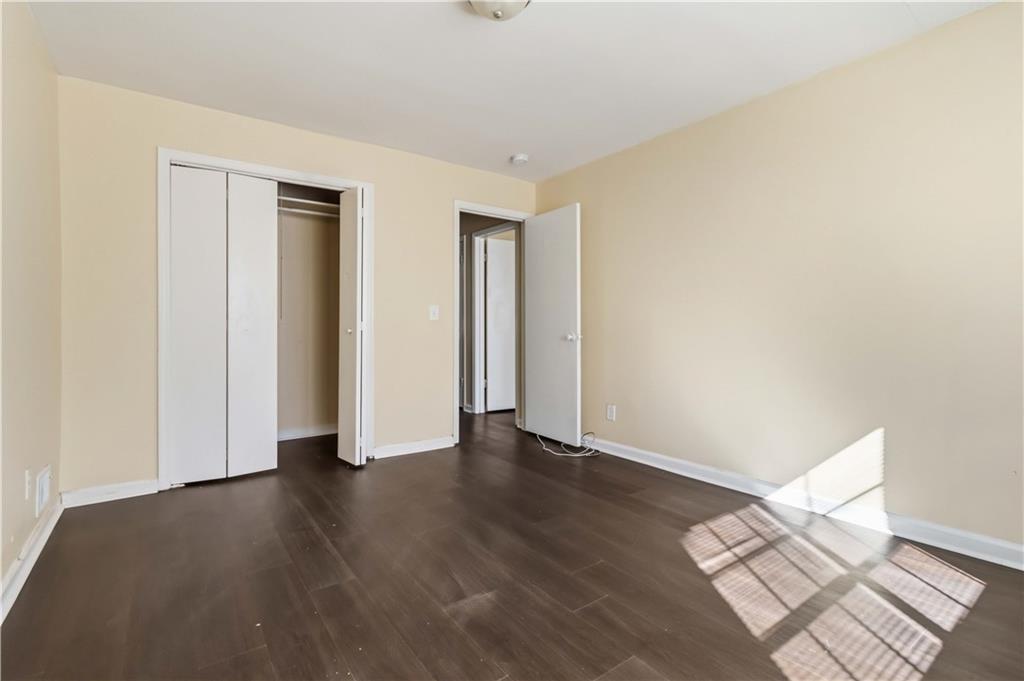 119 Plantation Circle Clarkston, GA 30021 - Photo 17 of 25 an empty room with wooden floor and closet