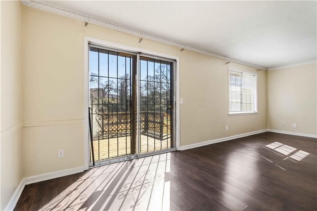 119 Plantation Circle Clarkston, GA 30021 - Photo 7 of 25 a view of an empty room with wooden floor and a window