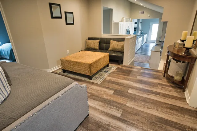 a bed sitting in a bedroom next to a window