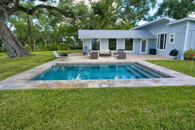 a view of a patio with garden and furniture