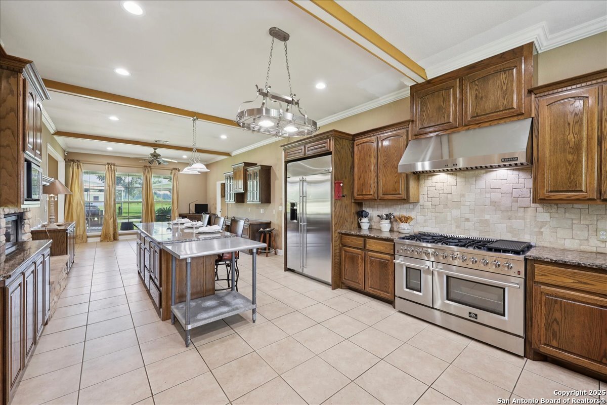 6900 Meyers Road Orange, TX 77632 - Photo 28 of 49 a kitchen with stainless steel appliances granite countertop a stove and cabinets