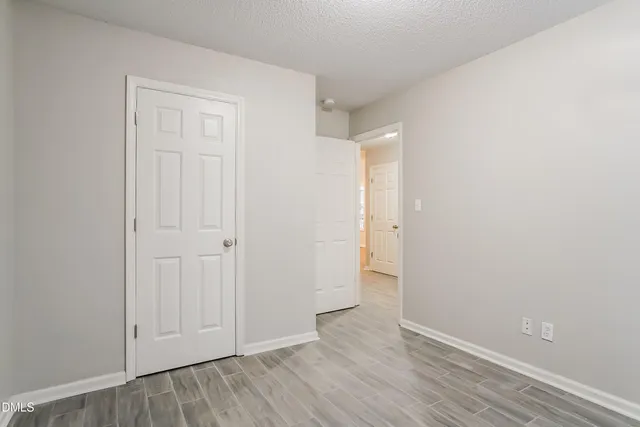 an empty room with wooden floor