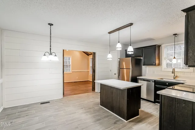 a kitchen with a refrigerator stove and sink