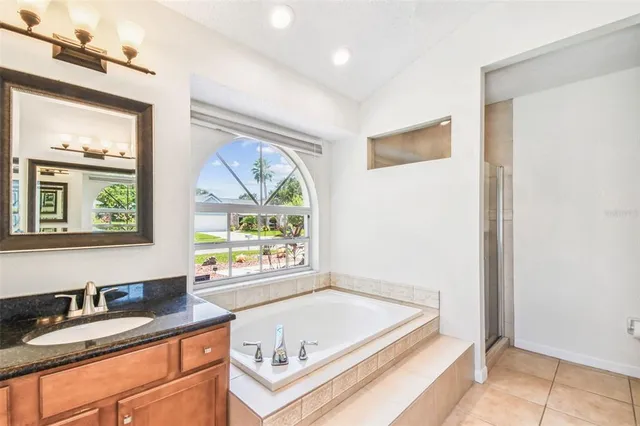 a kitchen with stainless steel appliances granite countertop a stove a refrigerator and a microwave