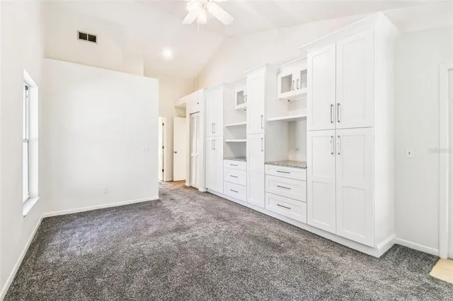 a view of a kitchen with a sink and a window