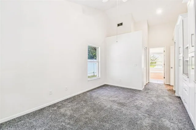 a view of empty room with wooden floor and fireplace