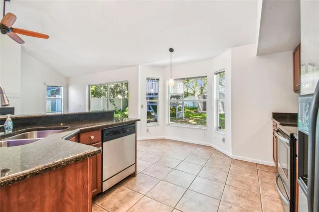 a view of empty room with wooden floor and fireplace