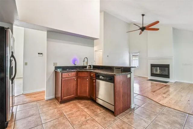 a view of a kitchen with a window and wooden floor