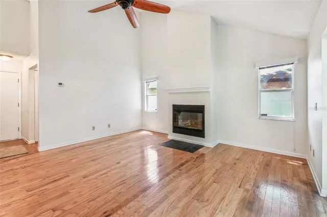 an empty room with a window and a fan