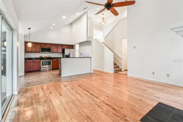 an empty room with closet and a chandelier fan