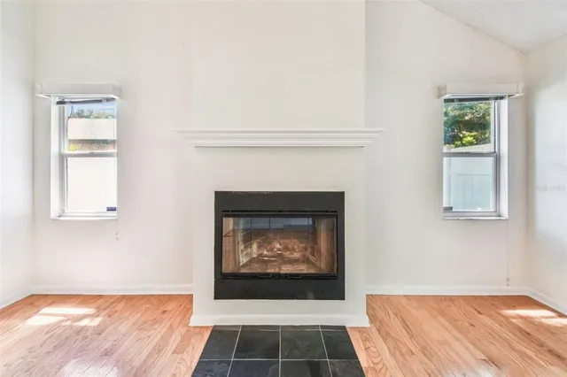 an empty room with windows and closet