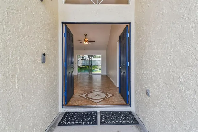 a view of an empty room and window chandelier fan