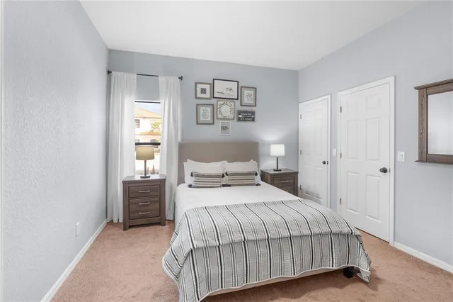 a bedroom with a bed and window